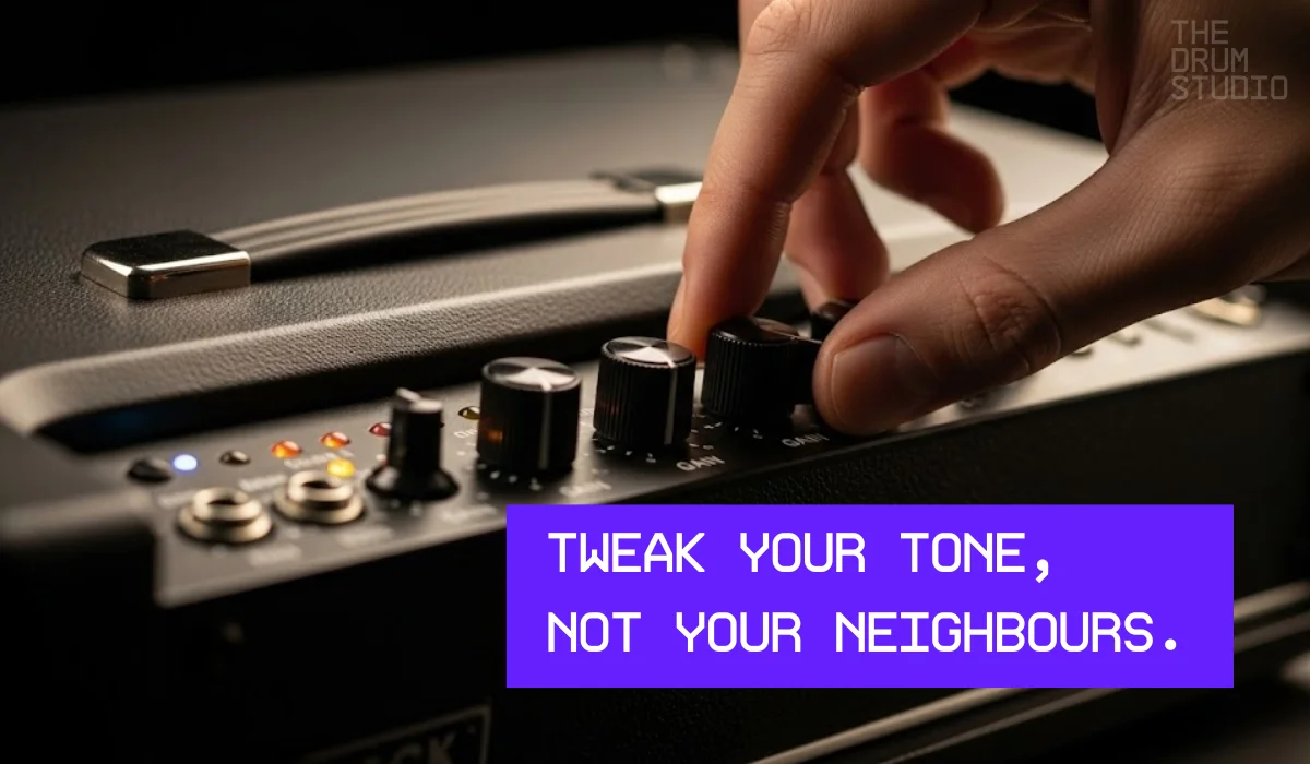 Hand adjusting tone knob on a black guitar amplifier.