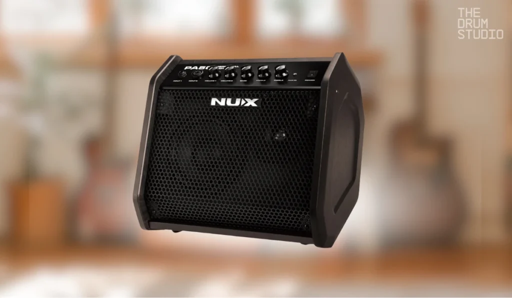 Black NUX drum amplifier with control knobs on top panel.
