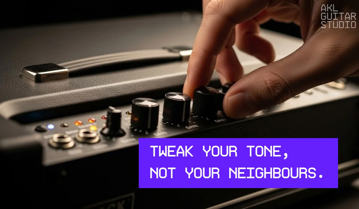 Hand adjusting tone knob on a black guitar amplifier.